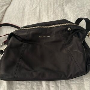 Trina Turk black leather handbag with dust cover new never been used